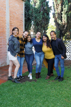 group of latin and multigenerational people or family together in a terrace outdoors in Mexico Latin america. Portrait of diverse hispanic group of friends
