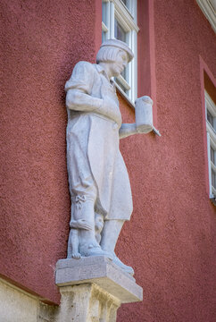 Furth, Bavaria, Germany - 15 July 2026: Historic former Bergbrau inn, featuring a portal statue of a brewer holding a beer mug and a small monkey at his feet.