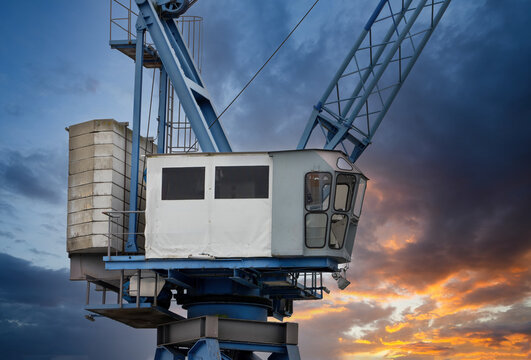 Industrial Harbor Crane at Sunset with Dramatic Sky