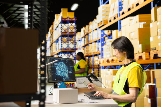 Warehouse worker uses AI tools to scan and register barcodes, applying automation to package tracking software and e-commerce fulfillment operations.