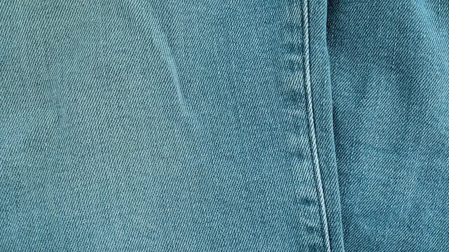 Light blue denim fabric jeans texture moving background