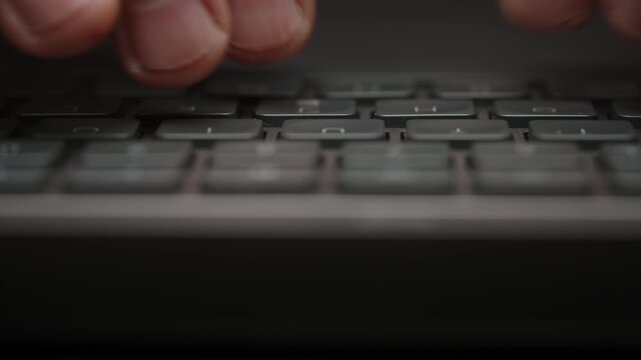 Close-up male hands typing on black keyboard, cinematic shot camera smoothly slides parallel to keys. Detailed footage of remote work, business communication, productivity and modern digital workflow