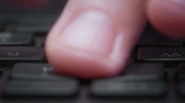 Close-up macro timelapse male hands typing rapidly on keyboard with subtle motion blur, camera smoothly slides parallel to keys. Dynamic footage of remote work, business activity and digital workflow