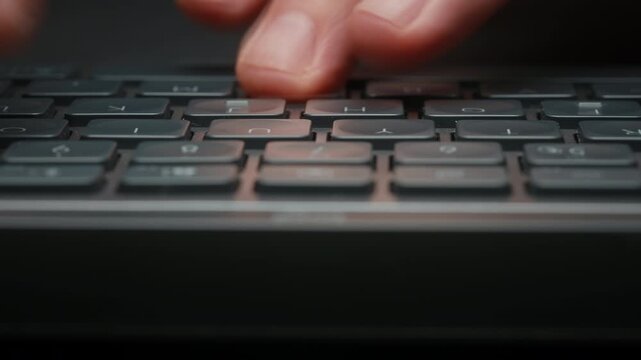 Dolly shot close-up timelapse male hands typing rapidly on keyboard with motion blur, camera smoothly slides parallel to keys. Dynamic shot remote work, business activity and digital workflow indoors