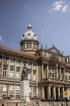 Birmingham, United Kingdom - 20 July 2026: View of the Birmingham Museum and Art Gallery with the Queen Victoria statue in the foreground under a clear blue sky.