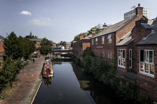Birmingham, England, United Kingdom - 20 July 2026: View of the historic canal and narrowboats along the towpath by The Malt House in Birmingham, England, United Kingdom.
