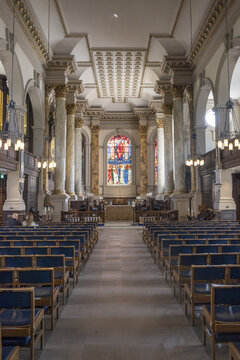 Birmingham, England, United Kingdom - 20 July 2026: View of the interior of St Philip's Cathedral in Birmingham, featuring ornate columns, stained glass windows, and rows of blue chairs.