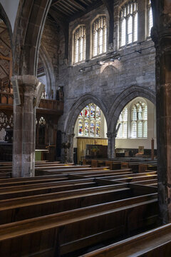Nottingham, England, United Kingdom - 15 July 2026: View of the interior of St Mary's Church featuring rows of wooden pews, historic stone arches, and intricate stained glass windows.