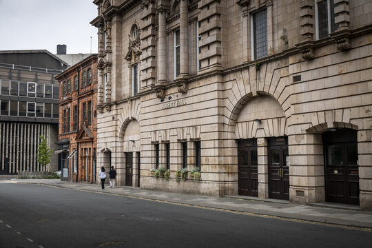 Nottingham, United Kingdom - 15 July 2026: View of the historic Albert Hall building with its stone facade, arched entrances, and pedestrians walking along the sidewalk.