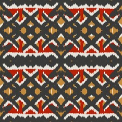 Fototapeta premium Seamless ethnic ikat pattern with bold red and gold geometric motifs on a dark grey background. Tribal fabric design perfect for bohemian prints, wallpaper, and creative decor.