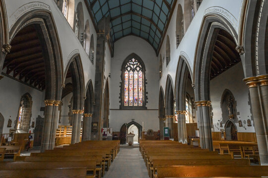 Sheffield, England - 15 July 2026: View of the interior of the Cathedral Church of St Marie featuring gothic arches, wooden pews, and stained glass windows.