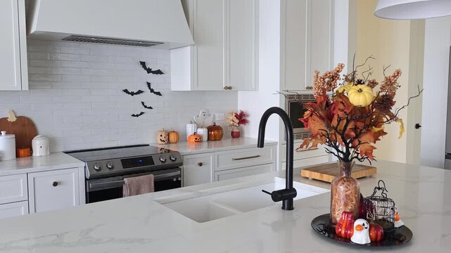 Beautiful modern kitchen with Halloween cookware and decor display. Slow panning motion.
