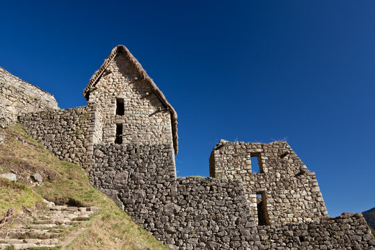 Ancient Inca stone house and ruins in Machu Picchu citadel Peru
