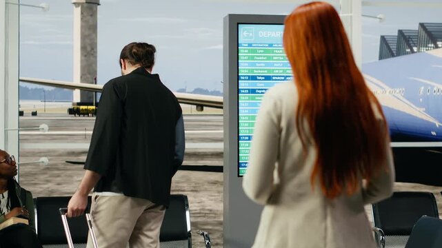 A man and woman share a heartfelt farewell in an airport terminal, hugging at the departure gate while facing sorrow and separation in a long-distance relationship before departure abroad.