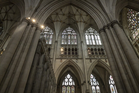 York, United Kingdom - 14 July 2026: View of the intricate Gothic architecture inside York Minster, featuring soaring stone columns, vaulted ceilings, and ornate stained glass windows.