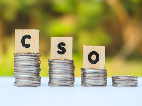 CSO or Chief Strategy Officer or Chief Security Officer acronym on wooden blocks with stacks of coins for corporate planning, business growth, and risk management concept