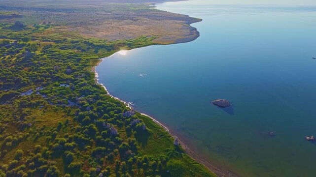 Vibrant aerial view captures Mono Lake shoreline surrounded by rugged mountains in California