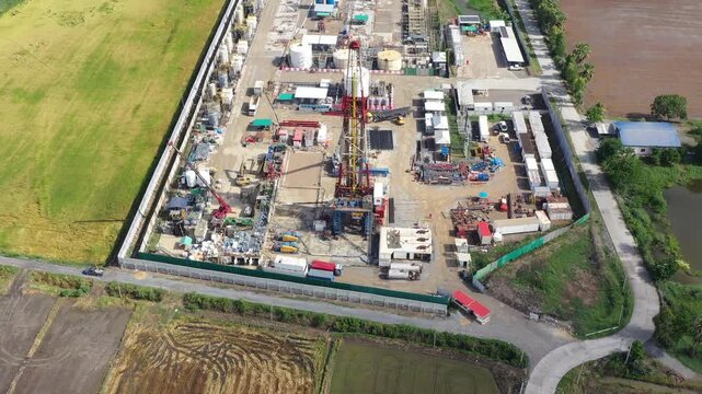 Aerial View of Land Drilling Rig and Oilfield Facility in Rice Fields