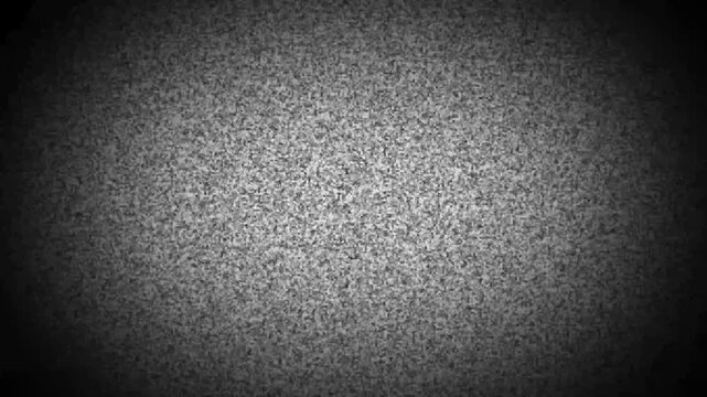 Analog television static noise with a dark vignette effect creating a circular focus on grainy black and white flickering signal interference