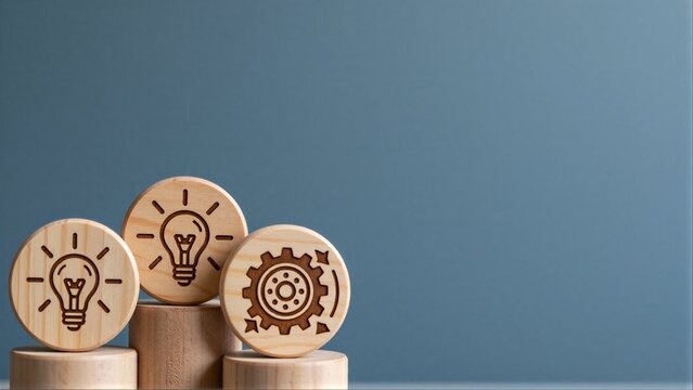 Wooden blocks with light bulb and gear symbols represent innovation, ideas, and mechanical progress.