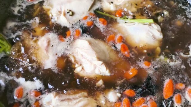 Cooking chicken soup with winter melon in pot, indoor Chiangmai Thailand.