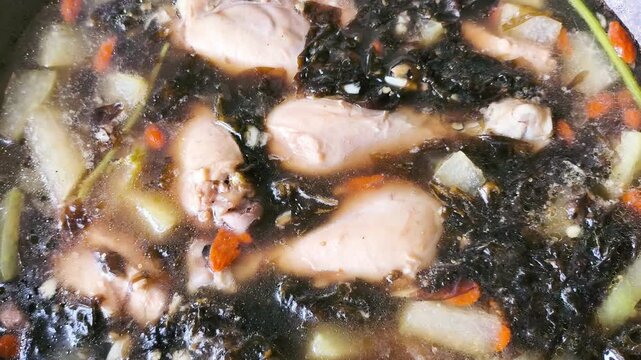 Cooking chicken soup with winter melon in pot, indoor Chiangmai Thailand.