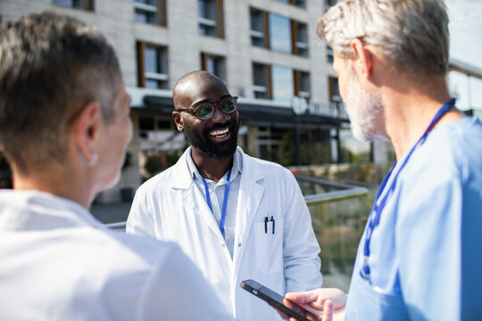 Doctors discussing patient care outside hospital