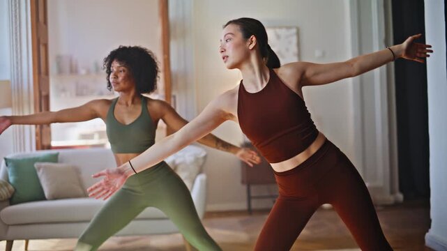 Yoga triangle pose home workout. Multiethnic women stretching arms overhead