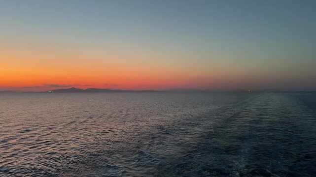 Viewing a fading sunset landscape via boat over the Adriatic Sea and island during late spring season 