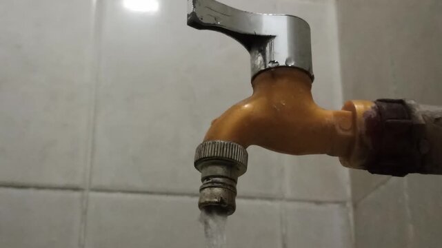 A water faucet equipped with a chrome lever handle for controlling water flow, showcasing a functional plumbing fixture commonly used in residential and commercial bathrooms or kitchens.