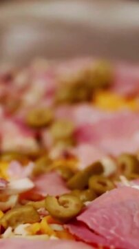 Fresh Pizza Topped with Ham and Olives