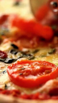 Fresh homemade pizza with melted mozzarella cheese and tomato slices