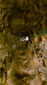 Walking through the Manly Wormhole tunnel at Queenscliff Head, Sydney, Australia, connecting Queenscliff and Freshwater beaches.
