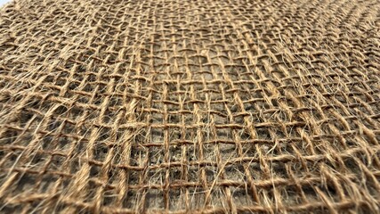 Fototapeta premium Natural jute woven fabric texture receding into the distance outdoors