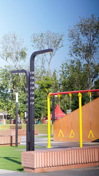 Empty Children Playground Area in City Square Park Under Clear Blue Sky