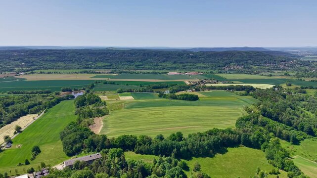 Aerial view of a rural landscape no visible action static scene, in rural countryside with fields and hills, with fields, hills, trees, from a aerial perspective from above perspective.