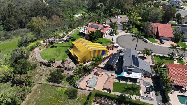 Aerial view of Termite fumigation tent, whole-structure treatment process that involves sealing a building in a tarp, releasing a lethal gas, and aerating the property