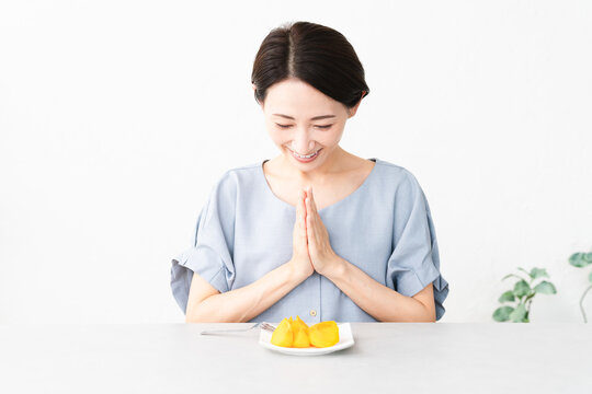 柿を食べる女性　食べ物イメージ