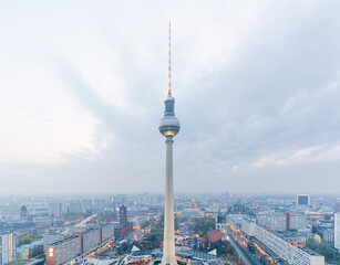 TV Tower rising above the city skyline under dramatic cloudy skies in Berlin, Germany © EllenXue