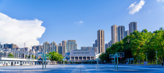 Urban Basketball Courts and Sports Complex with City Skyline © TranPhuoc