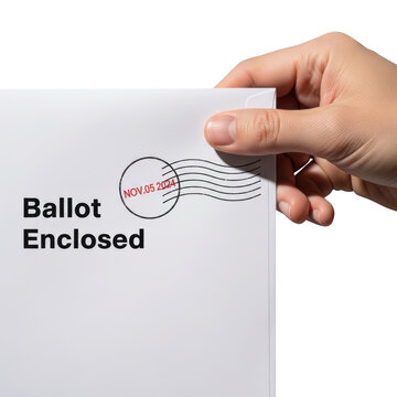 Hand holding sealed ballot envelope close.