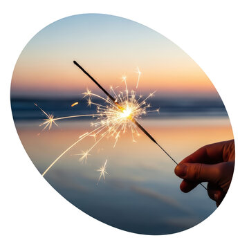 Hand holding sparkler at sunset.