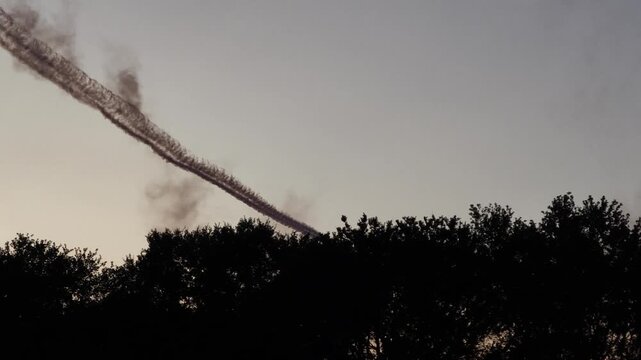 Airplanes performing aerobatic maneuvers with smoke trails