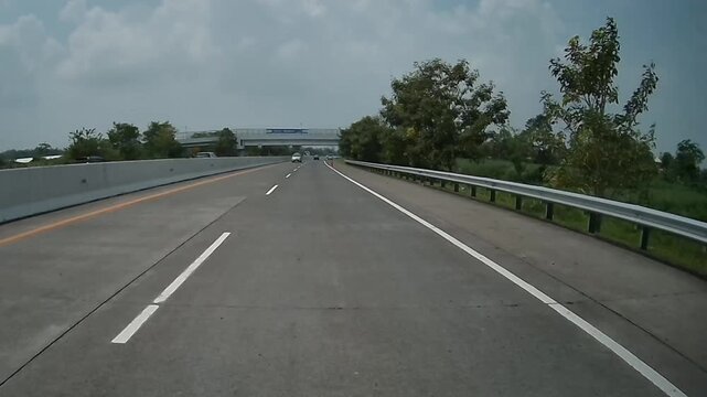 4K Rear Dashcam Footage of Vehicles Driving Beneath Pedestrian Overpass on Malang&ndash;Surabaya Toll Road, East Java, Indonesia