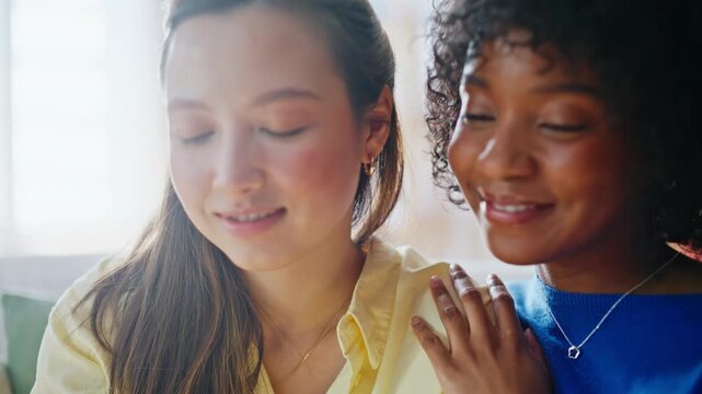 Multiracial couple sharing tender moment sofa. Closeup women talking home.