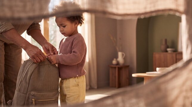 Parent and young child preparing a backpack together in a rustic home interior