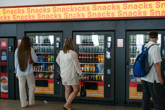 Antalya Airport, Turkey, 17 July 2026: Passengers buying drinks from vending machines at Antalya Airport, Turkey