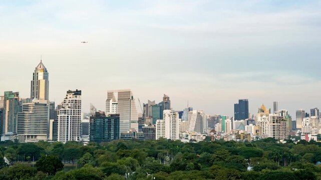 Bangkok central business district time-lapse from day to night, modern skyscrapers under changing sky.