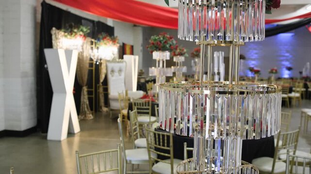 A decorative ornament and centerpiece add an elegant detail to a prepared table at a quinceanera reception.