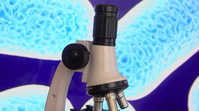 A laboratory microscope stands before a magnified E coli bacteria background symbolizing microbiology research